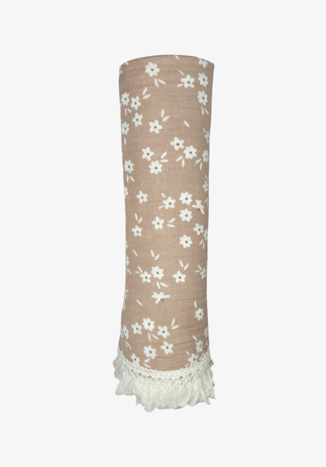 Rolled brown cotton baby blanket with white floral print and white fringed edges, placed on a light sandy background.