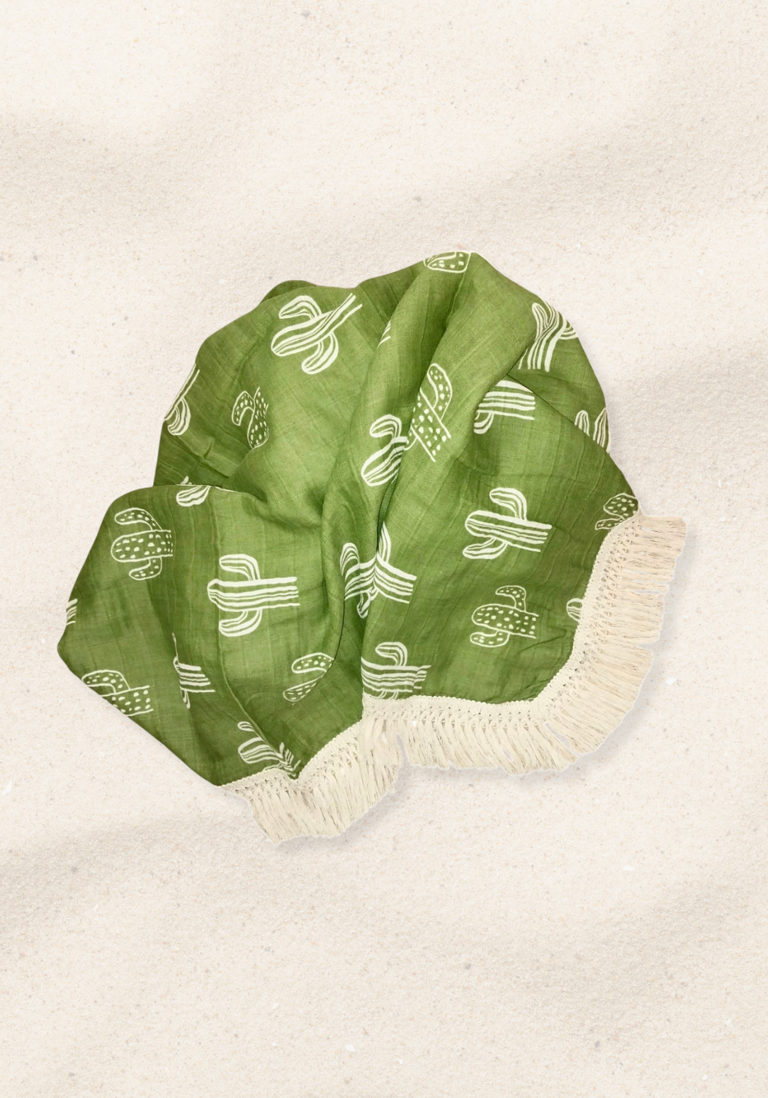 Green cotton baby blanket with white cactus print and cream fringe edges. Soft and breathable fabric.