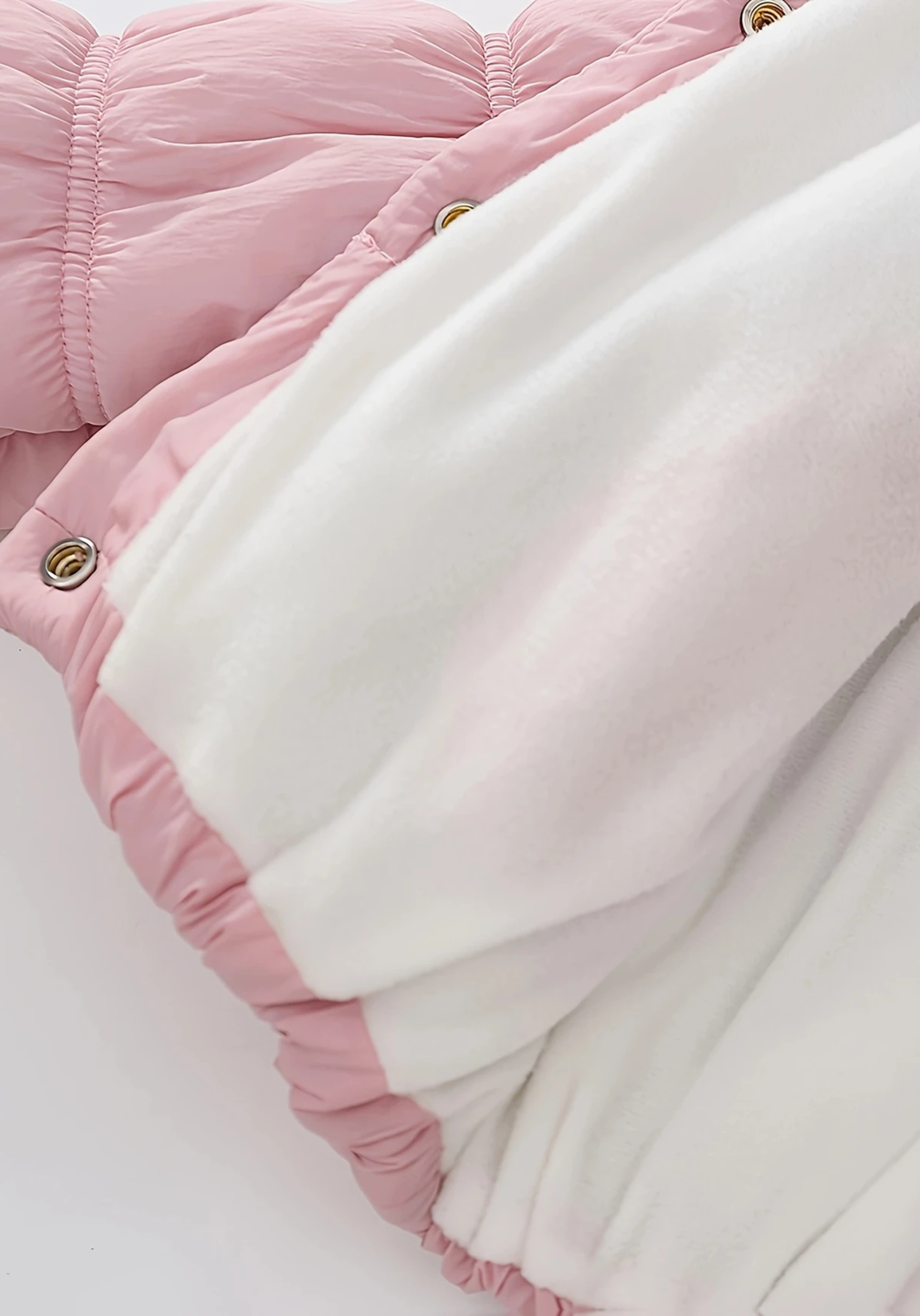 Close up view of toddler pink puffer jacket with ruched detailing and high collar