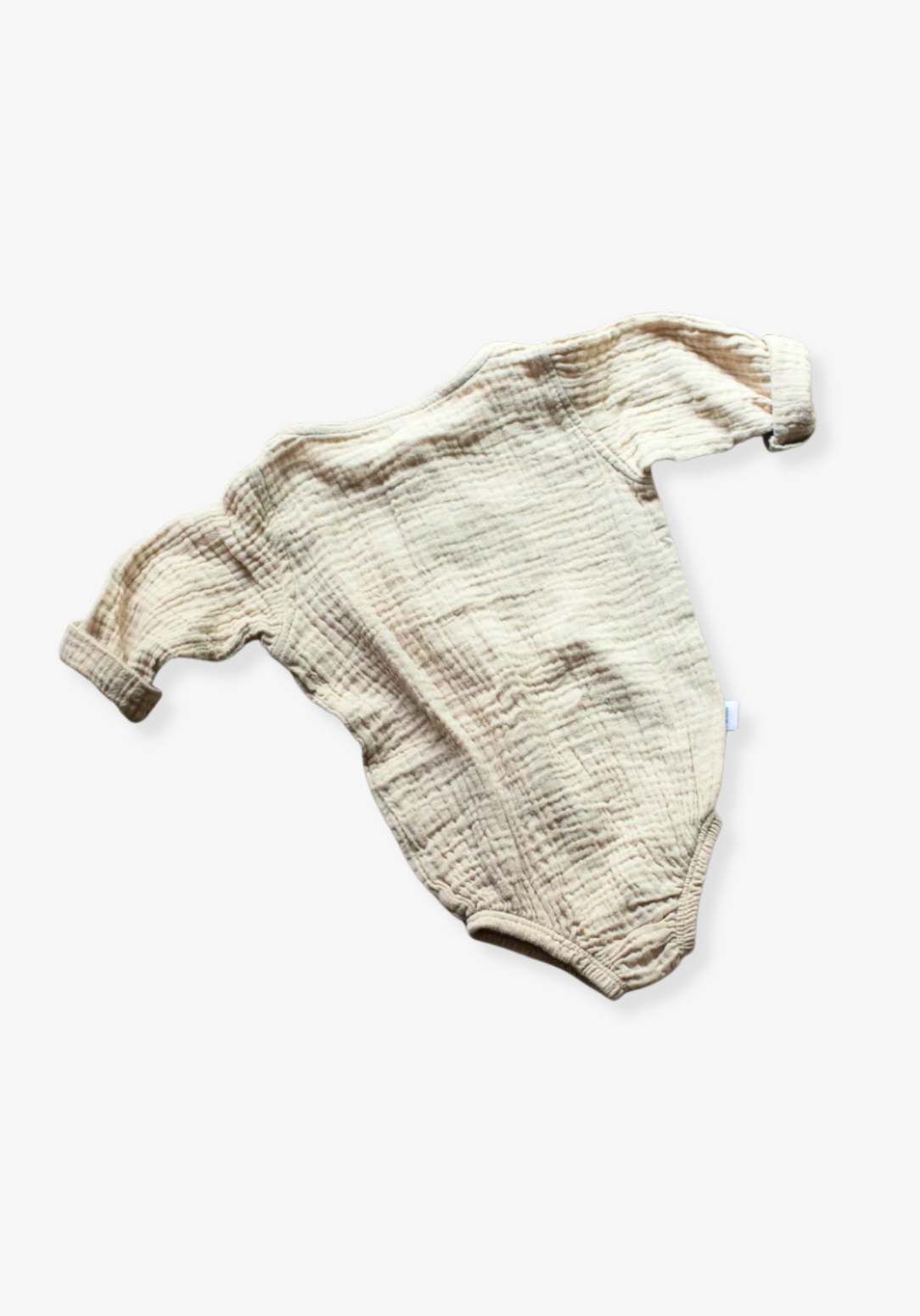 Organic cotton baby romper in beige with long sleeves and button-down front, displayed on a grey background
