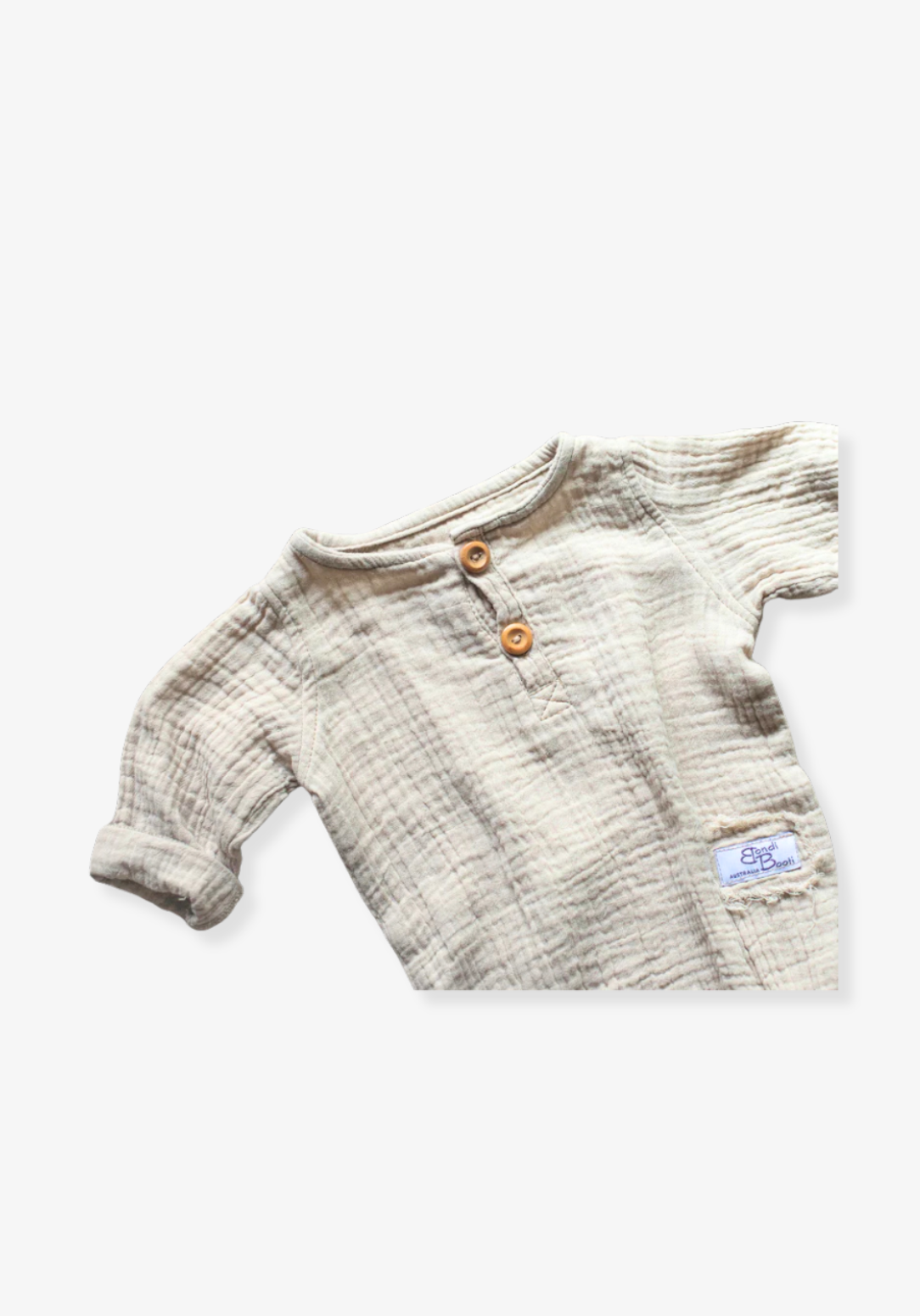 Organic cotton baby romper in beige with long sleeves and button-down front, displayed on a grey background