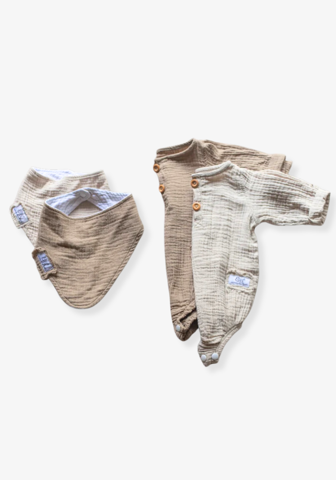 Organic cotton baby romper in beige with long sleeves and button-down front, displayed on a grey background