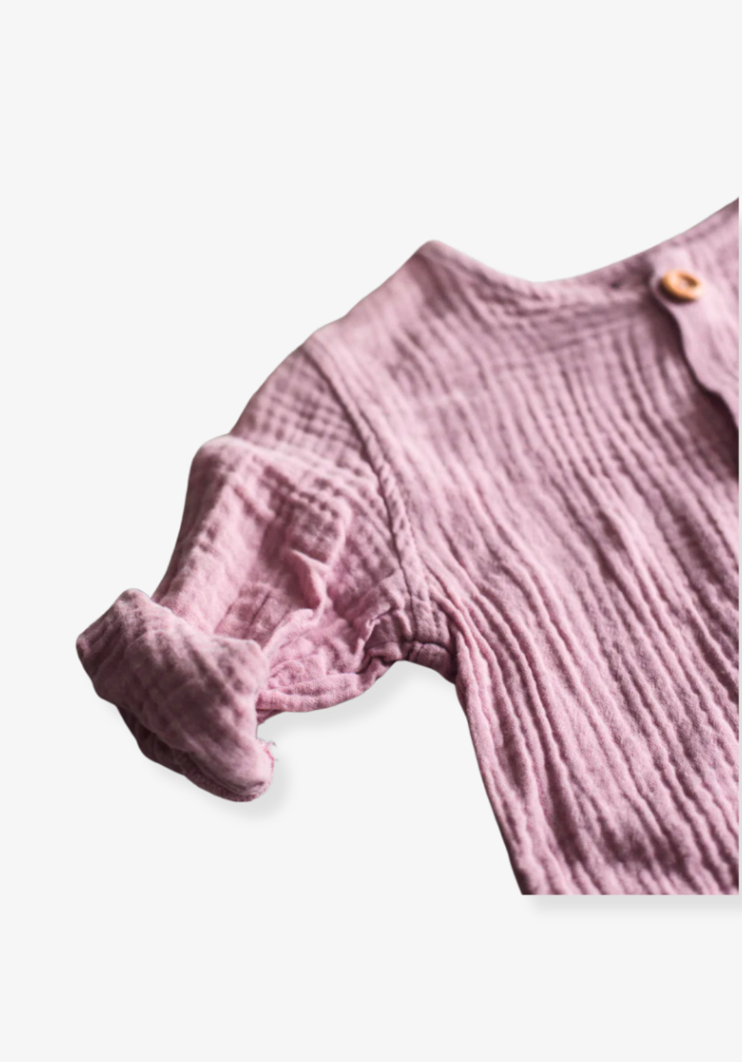 Dusty pink baby and toddler island-style shirt made from organic cotton with short sleeves and wooden buttons