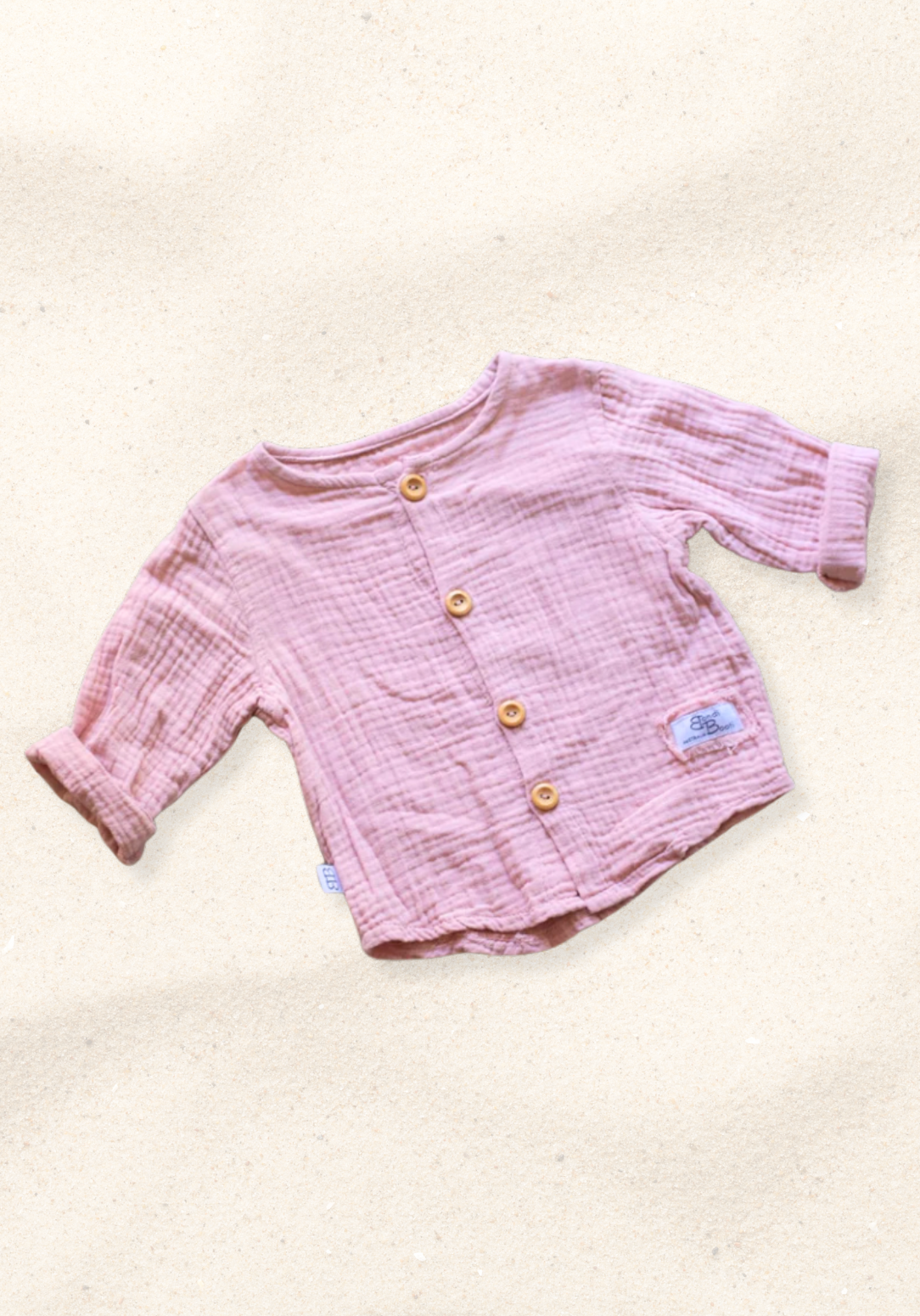 Dusty pink baby and toddler island-style shirt made from organic cotton with short sleeves and wooden buttons