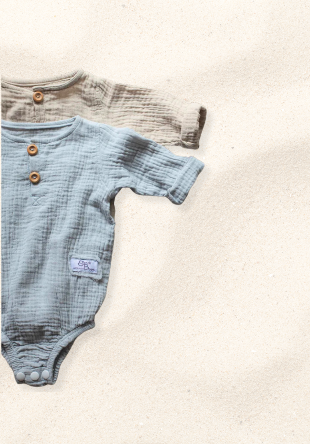 French grey long sleeve baby romper made from soft organic cotton with wooden button front and snap closures.