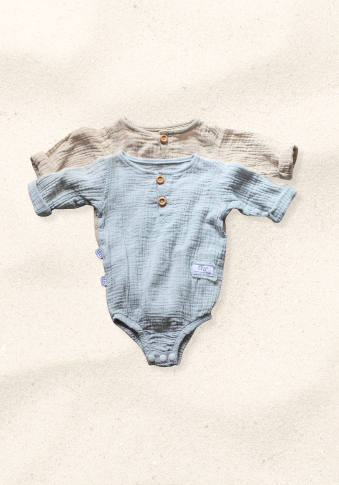 French grey long sleeve baby romper made from soft organic cotton with wooden button front and snap closures.