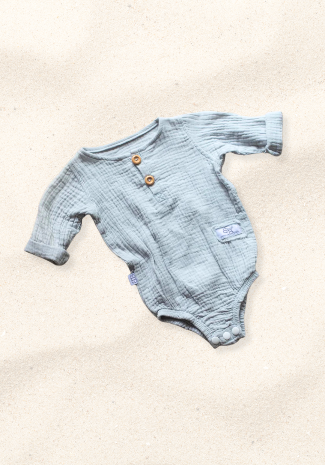 French grey long sleeve baby romper made from soft organic cotton with wooden button front and snap closures.