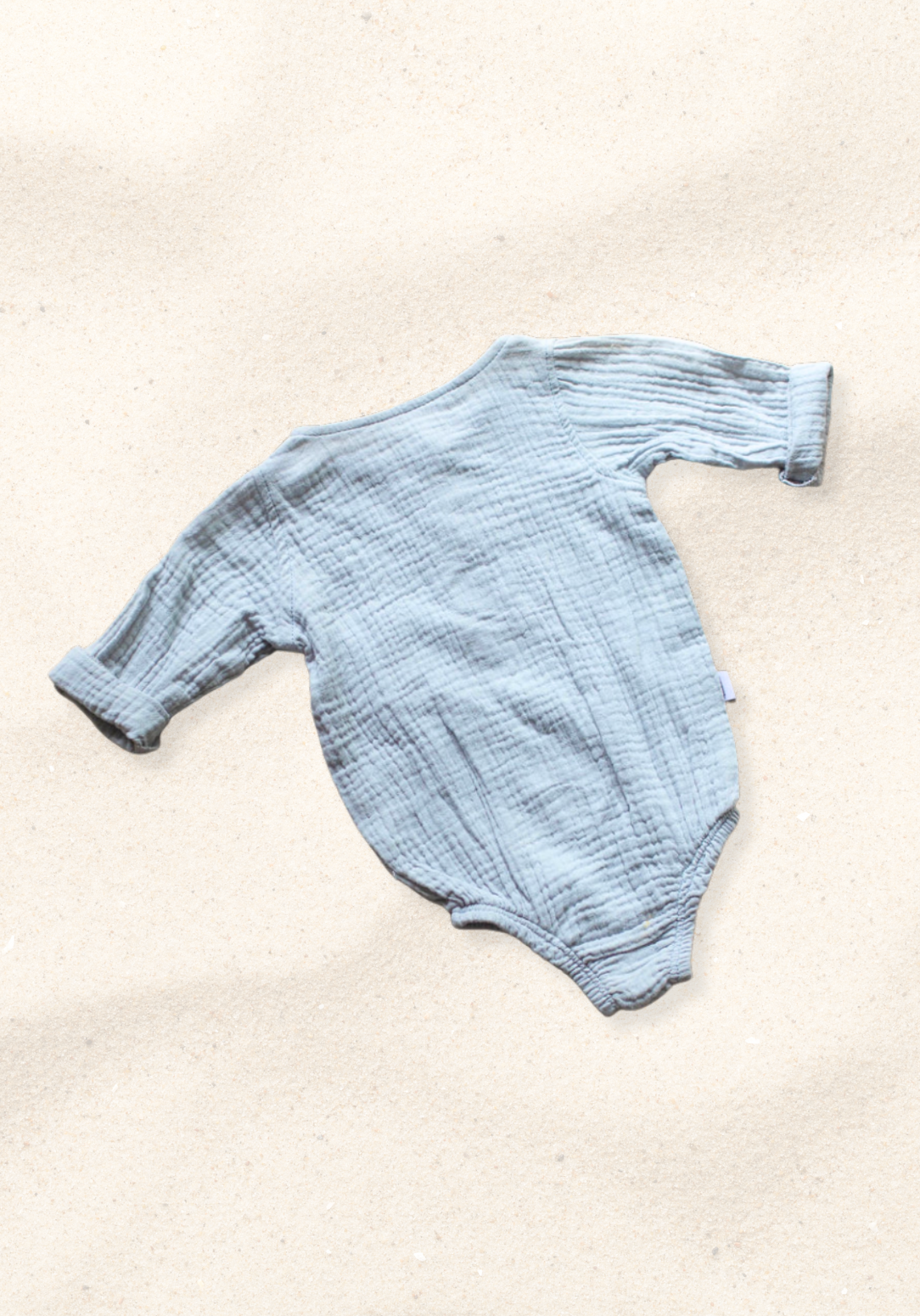 French grey long sleeve baby romper made from soft organic cotton with wooden button front and snap closures.