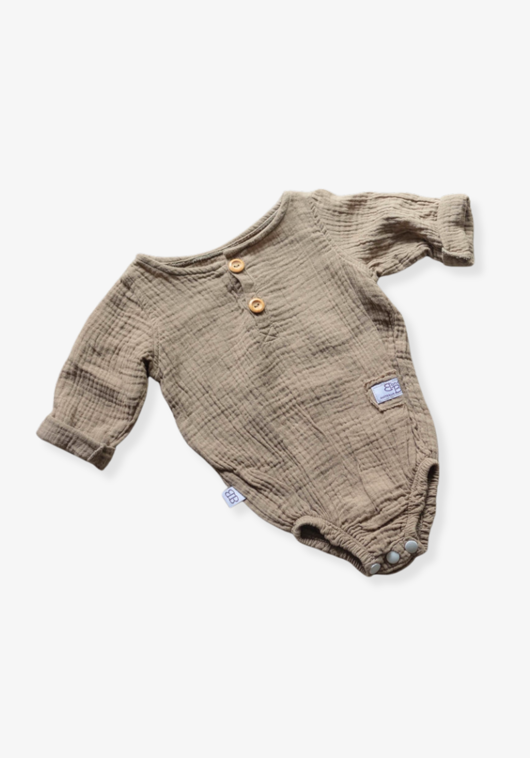 Long sleeve baby romper in mocha color crafted from organic cotton with snap closure and wood button details