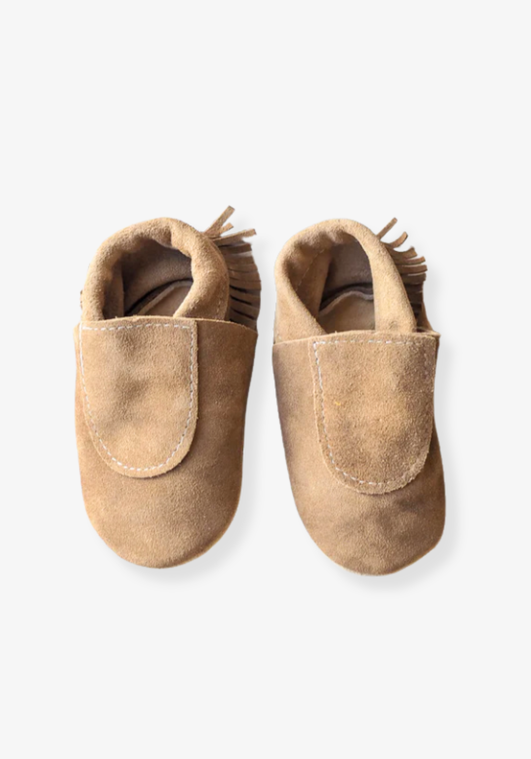 Soft sole baby moccasins in natural leather with fringe trim and suede finish