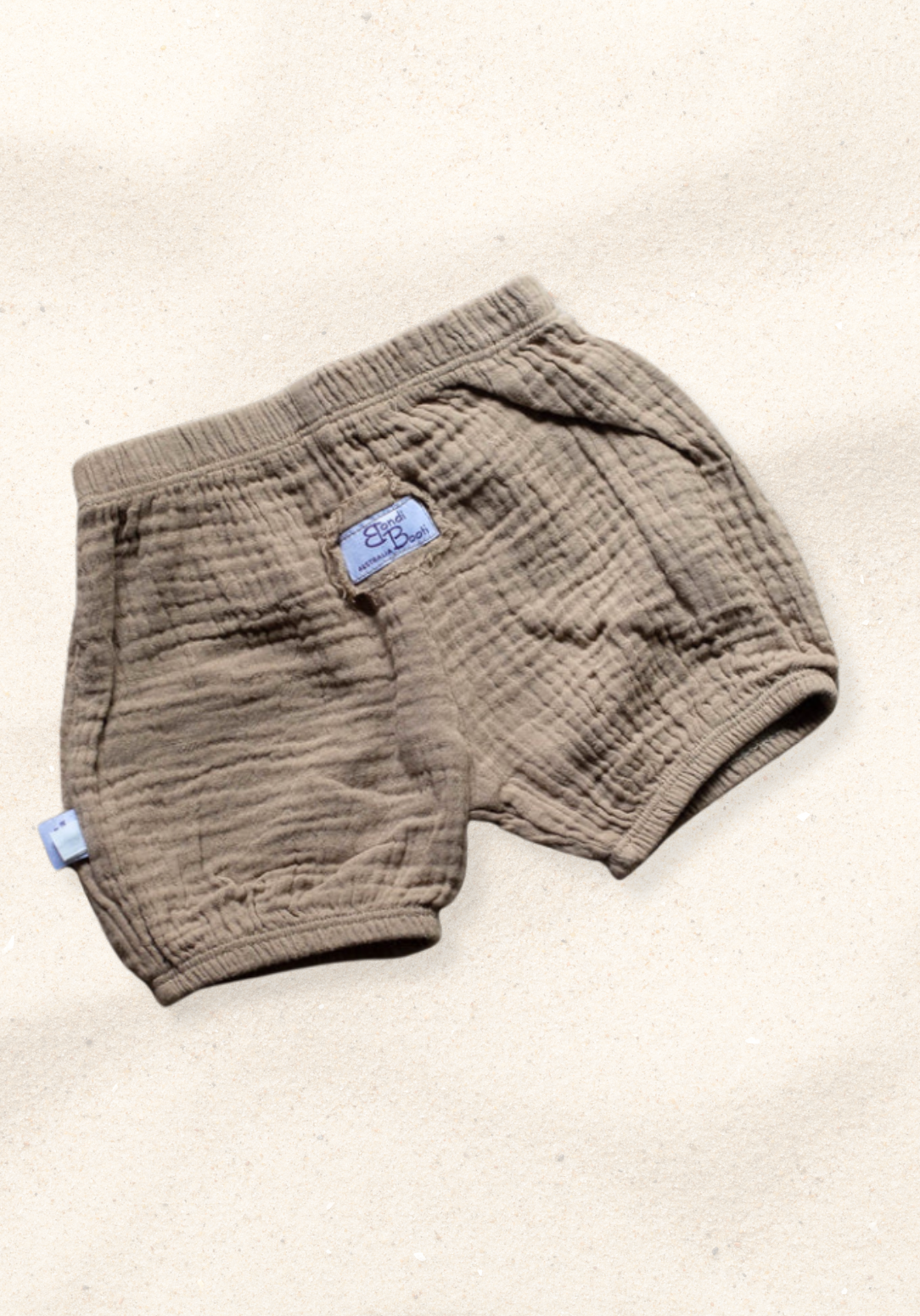 Mocha organic cotton baby bloomers with soft elastic waistband and leg openings, perfect for warm weather