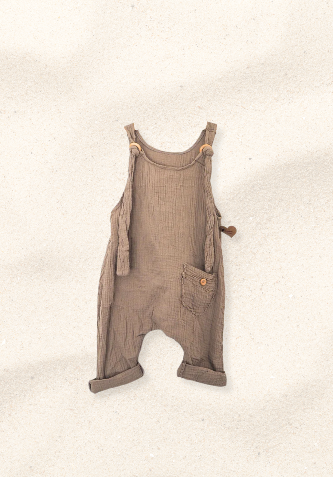 Mocha-colored toddler dungarees made from organic cotton with adjustable button straps and roomy fit