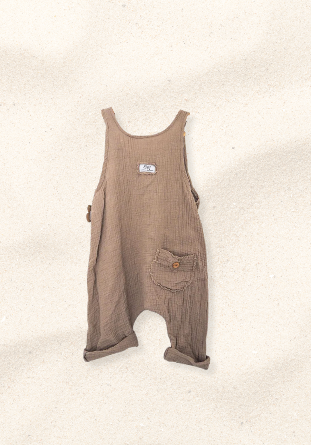 Mocha-colored toddler dungarees made from organic cotton with adjustable button straps and roomy fit