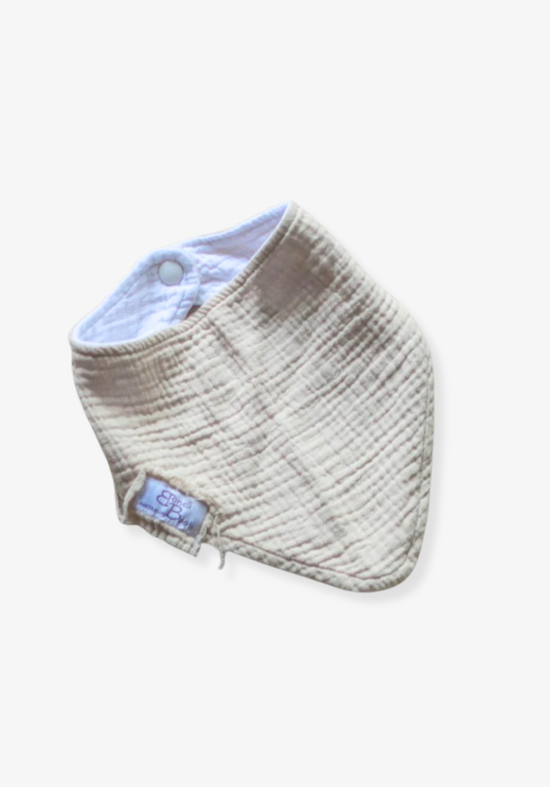 Soft beige organic cotton bandana dribble bib for babies with rounded shape and snap closure, displayed on a grey background