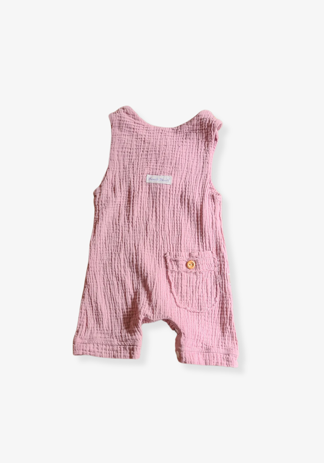 Dusty pink organic cotton baby overall onesie with wooden button shoulder straps and soft elastic leg openings