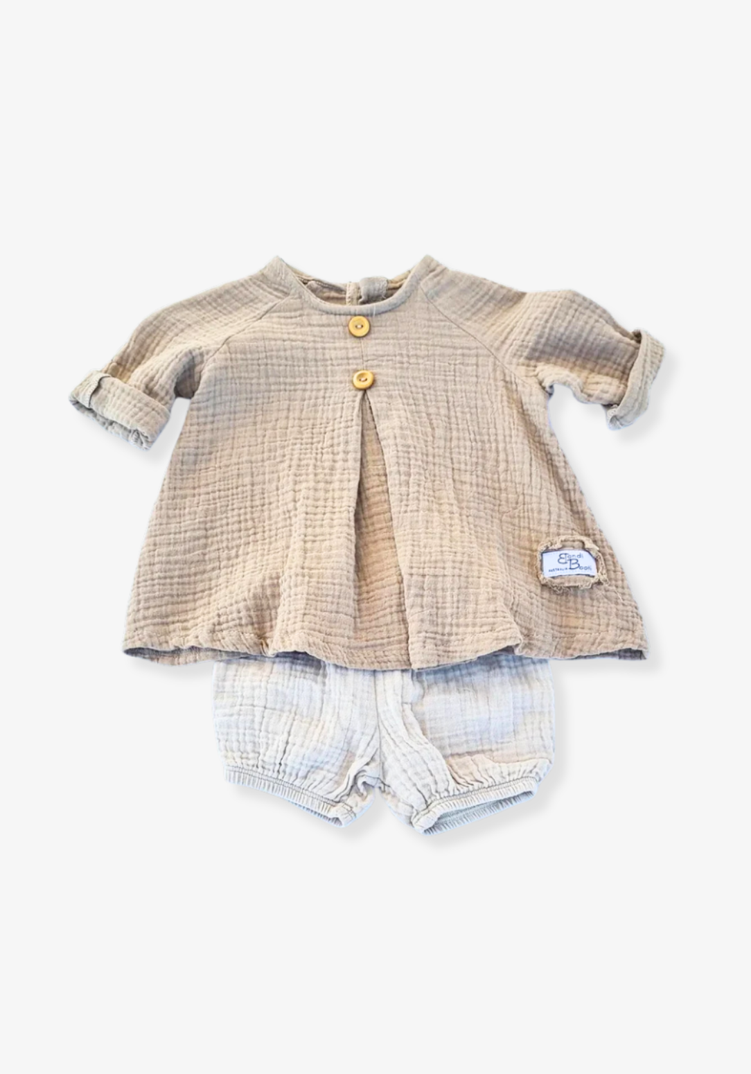 Mocha-colored cotton boho baby dress with embroidered hem, displayed on a light grey background for a neutral look