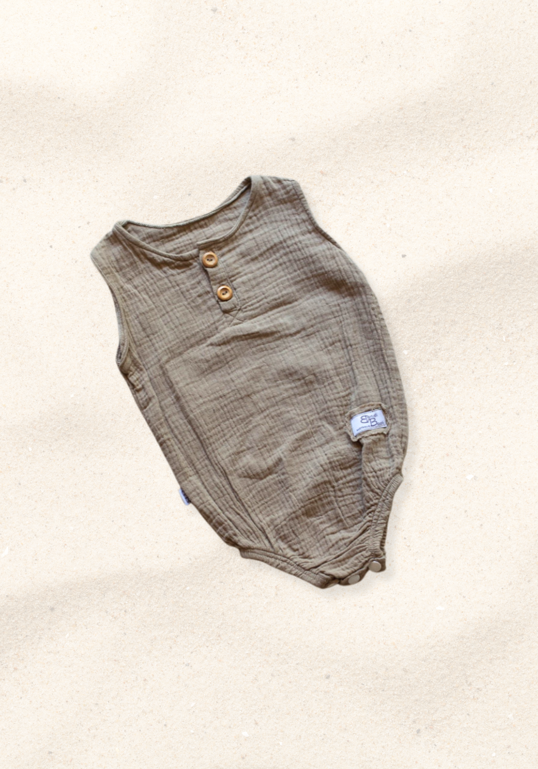 Mocha-colored organic cotton baby romper with short sleeves and front buttons