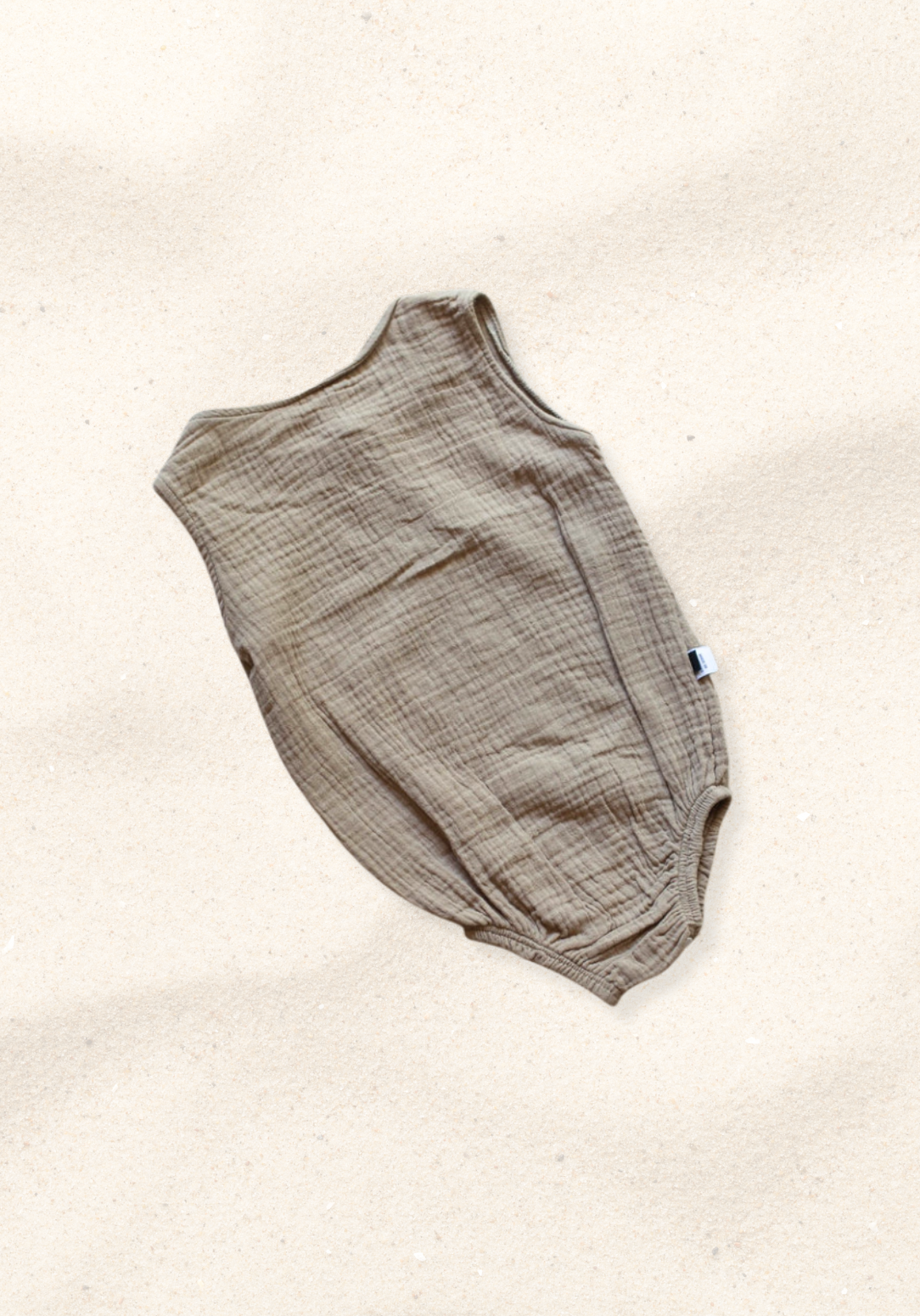 Mocha-colored organic cotton baby romper with short sleeves and front buttons