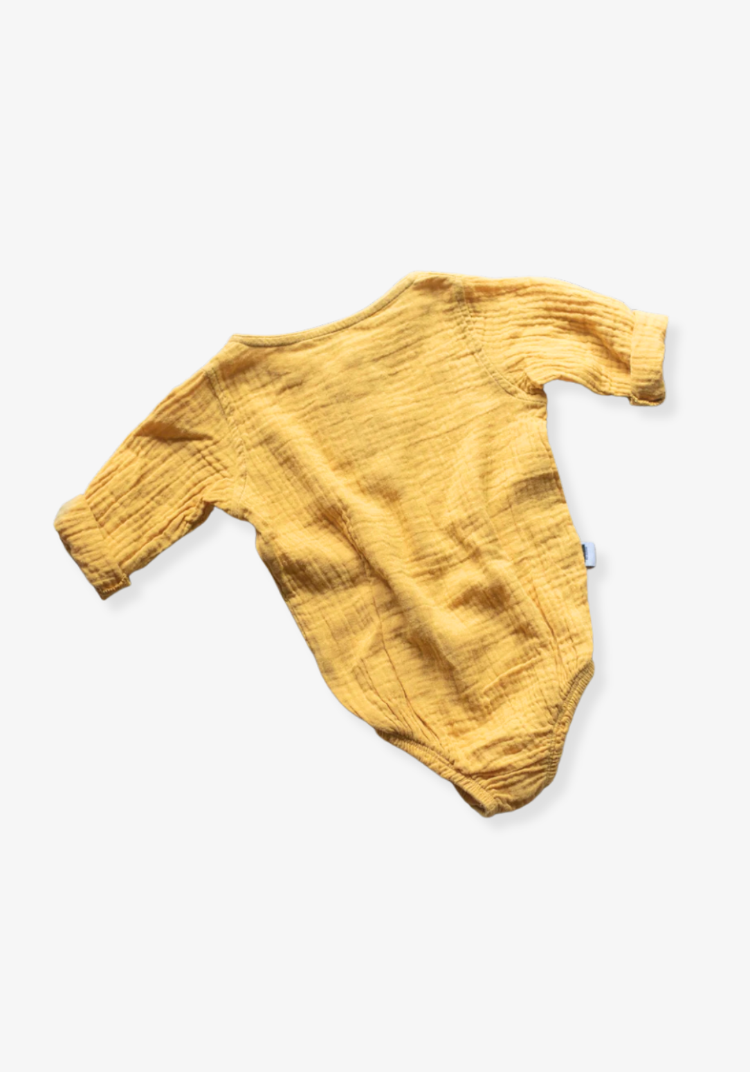 Mustard yellow long sleeve baby romper made from organic cotton with wooden buttons and snap closure.