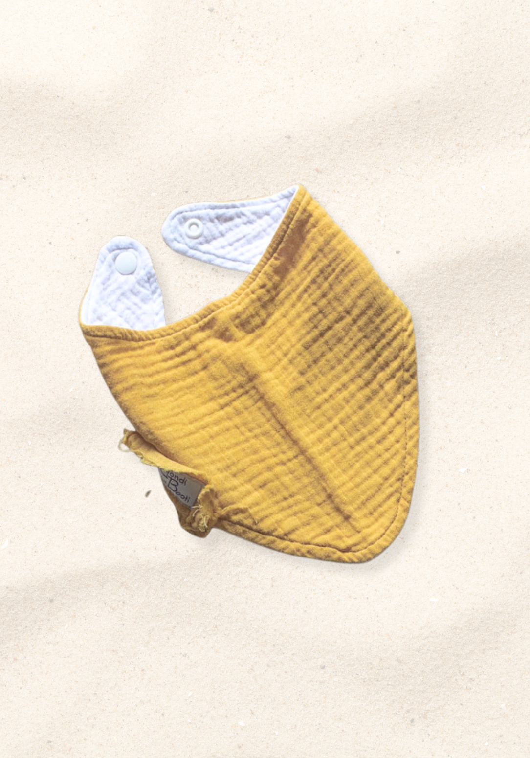 Mustard yellow organic cotton baby bandana dribble bib with soft fabric and snap closure.