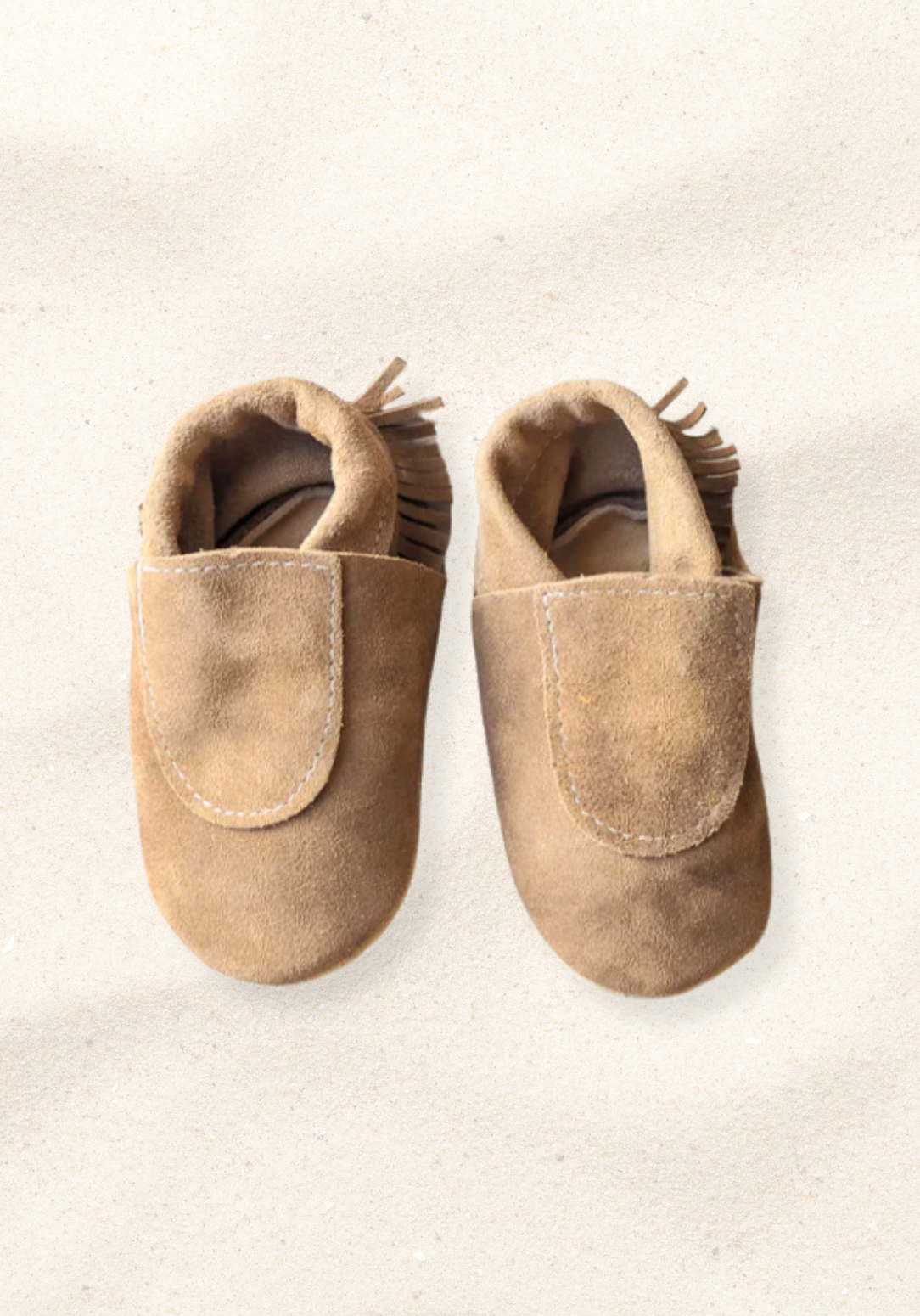 Soft sole baby moccasins in natural leather with fringe trim and suede finish
